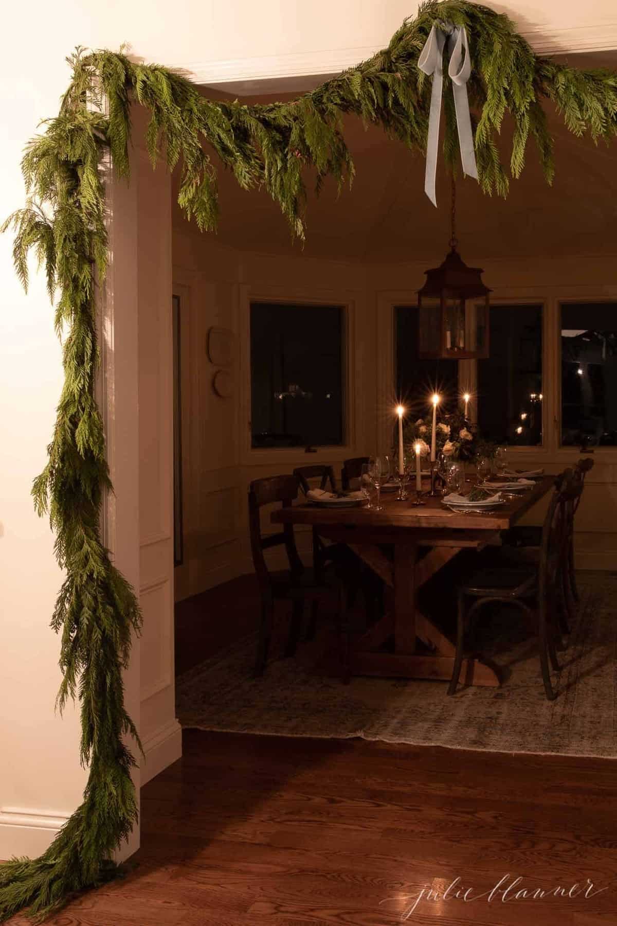 A dark candlelit room, set for Christmas dinner. 