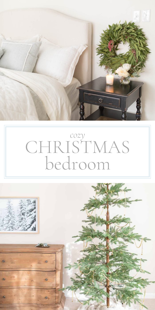 A bedroom with a christmas tree and a dresser.