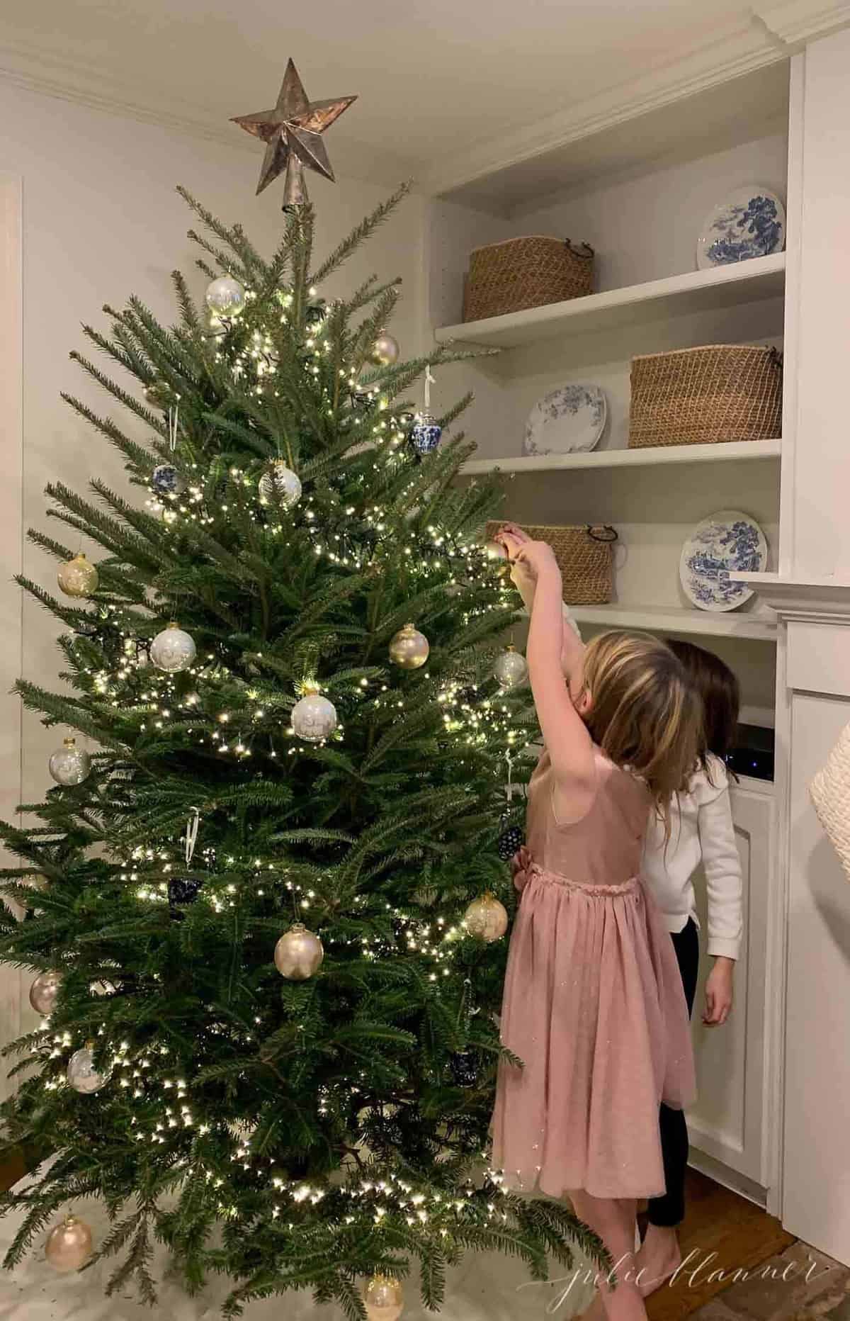 Little girls decorating a Christmas tree