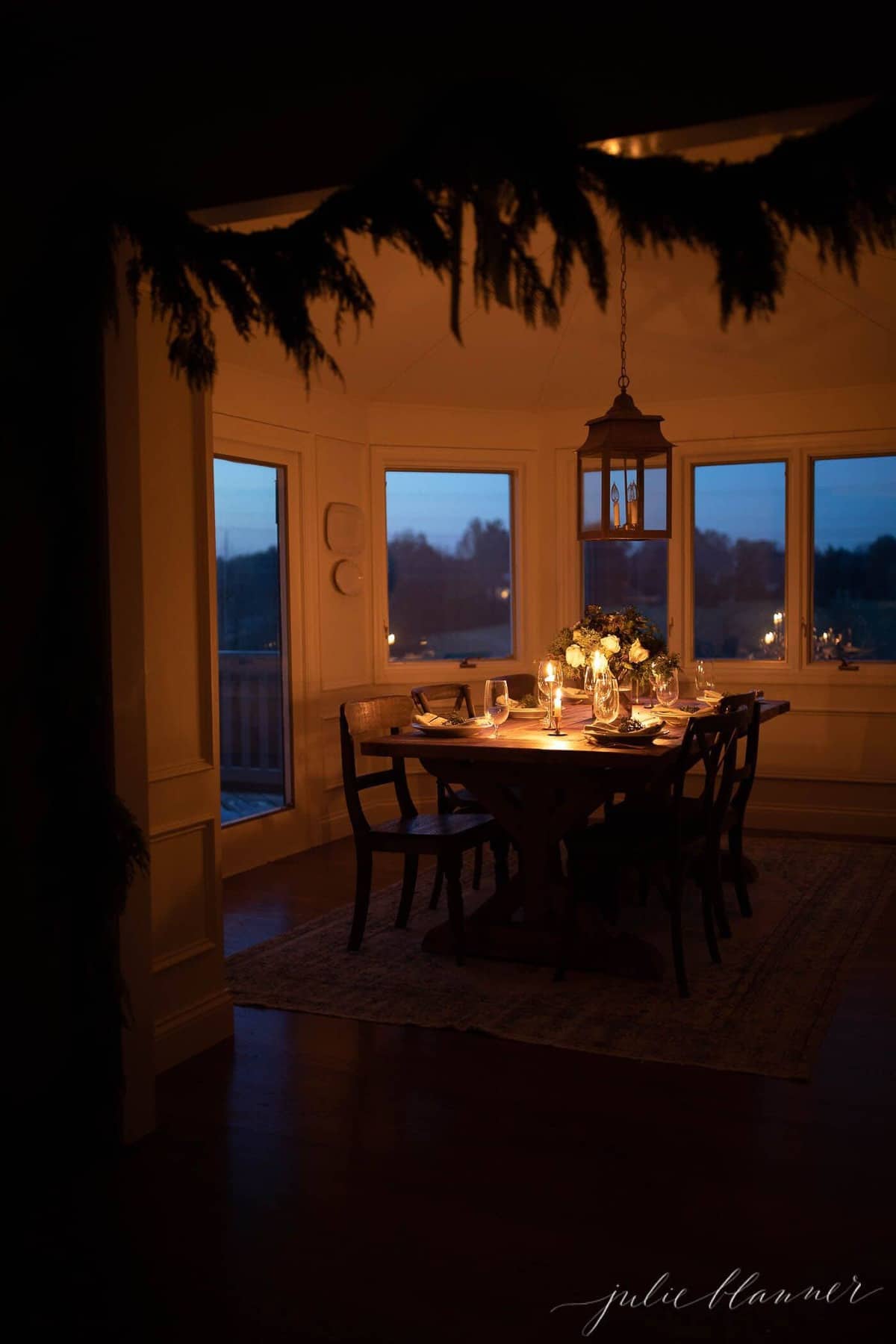 A dark candlelit room, set for Christmas dinner. 