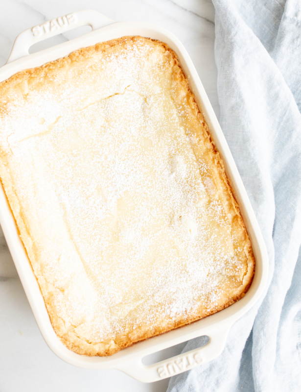 A white rectangular baking dish filled with a homemade gooey butter cake.