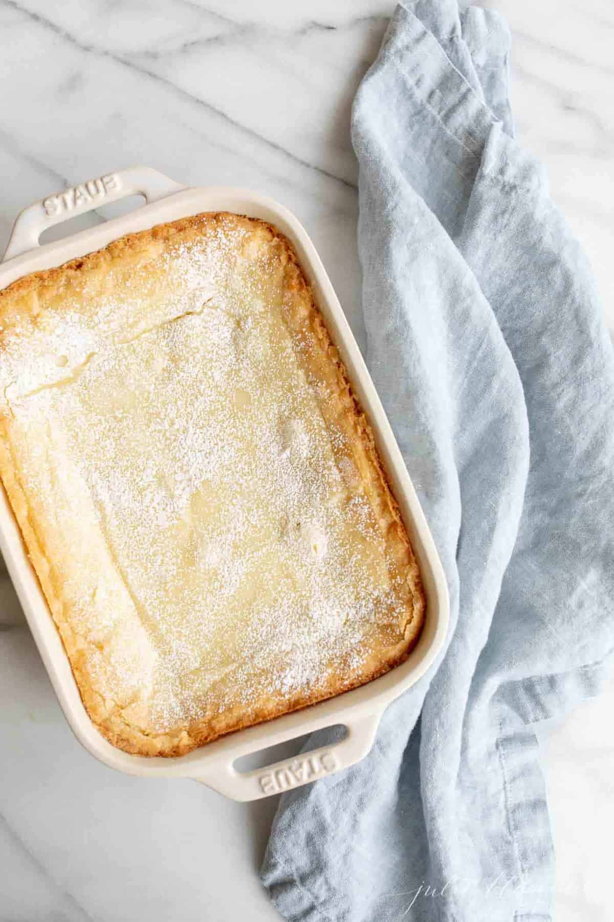 st louis gooey butter cake in baking dish with blue napkin