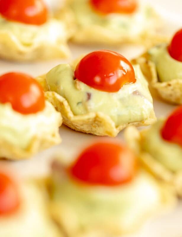 Guacamole bites on a white platter.