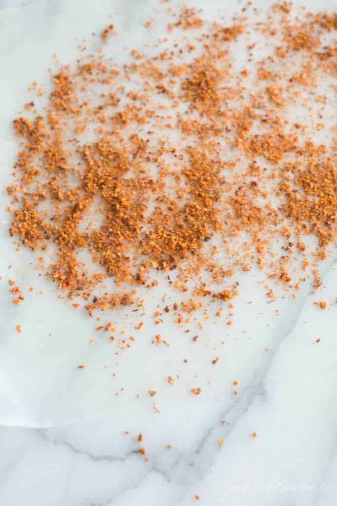 Marble surface with spices spread about.