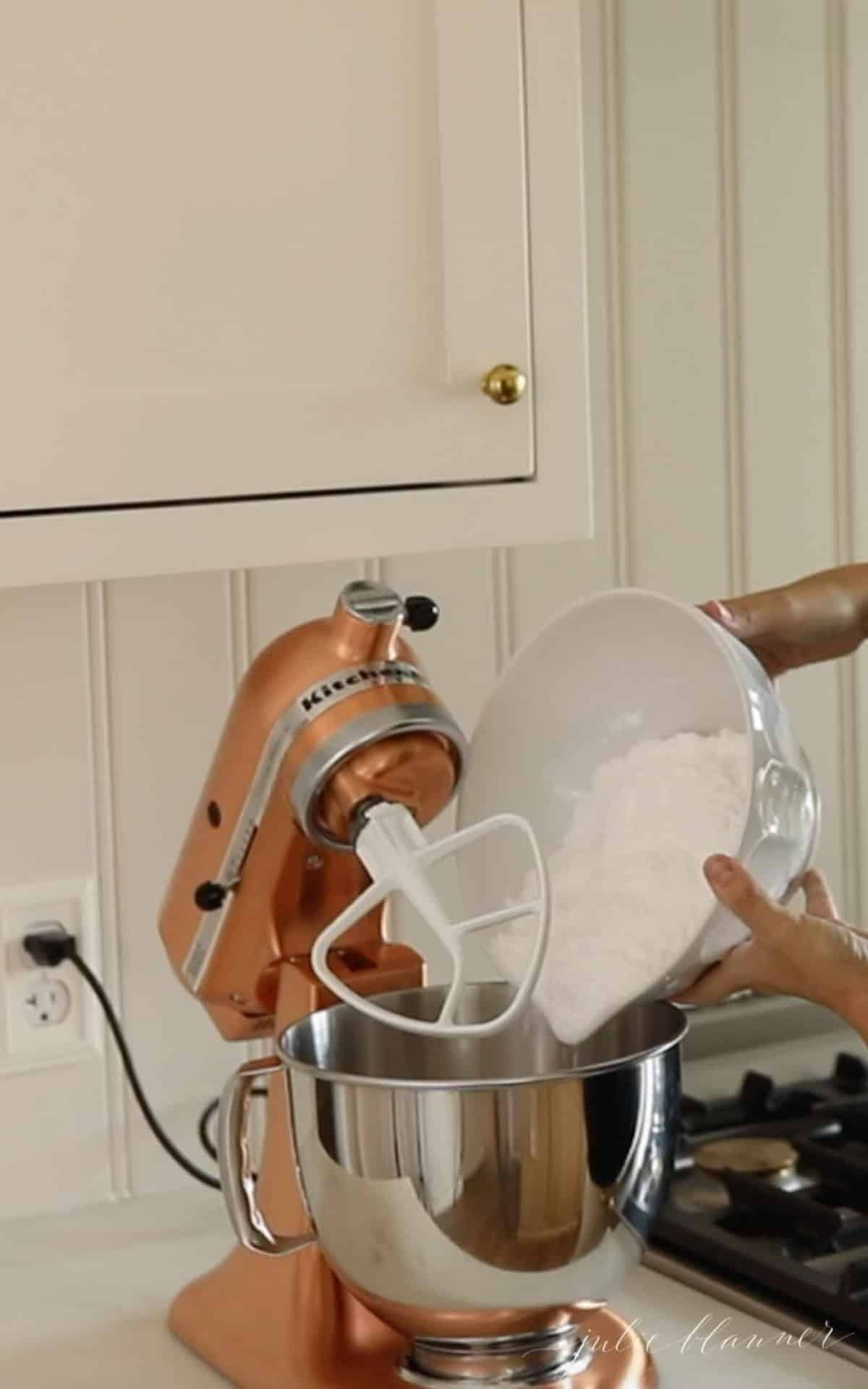 pouring powdered sugar into stand mixer