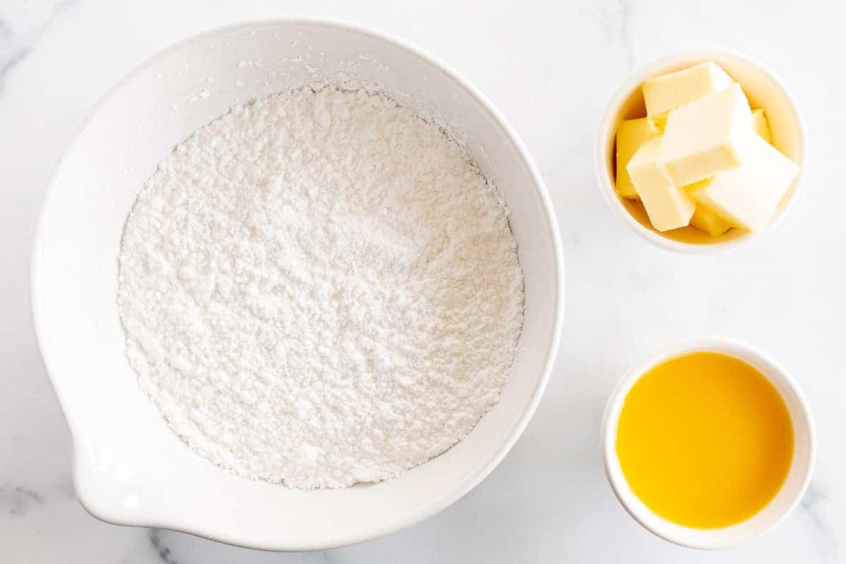 powdered sugar butter and orange juice in bowls