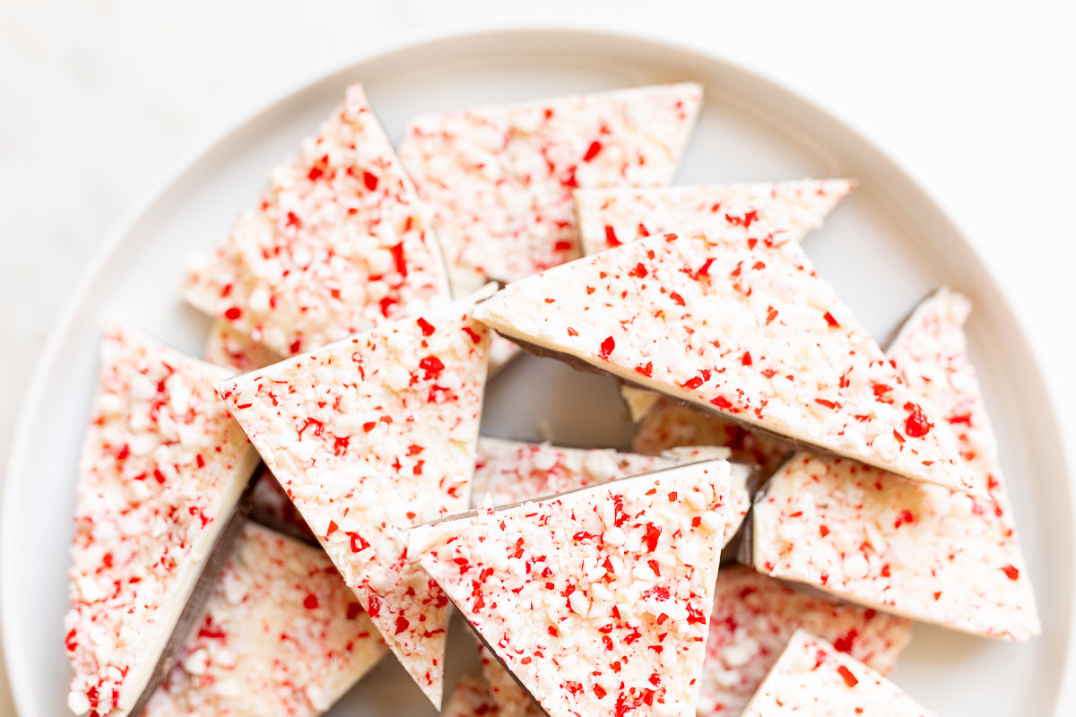 A festive plate of peppermint bark adorned with a delightful sprinkle decoration.