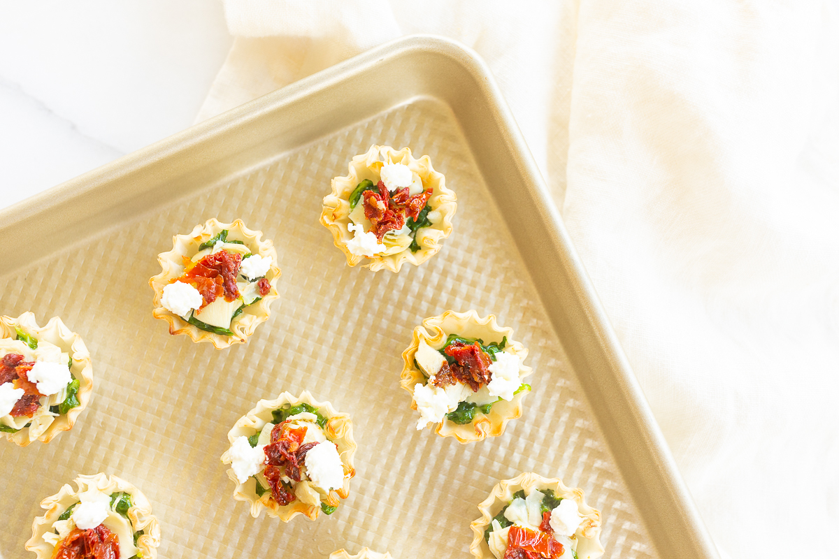 A tray of spinach dip bites on a baking sheet.