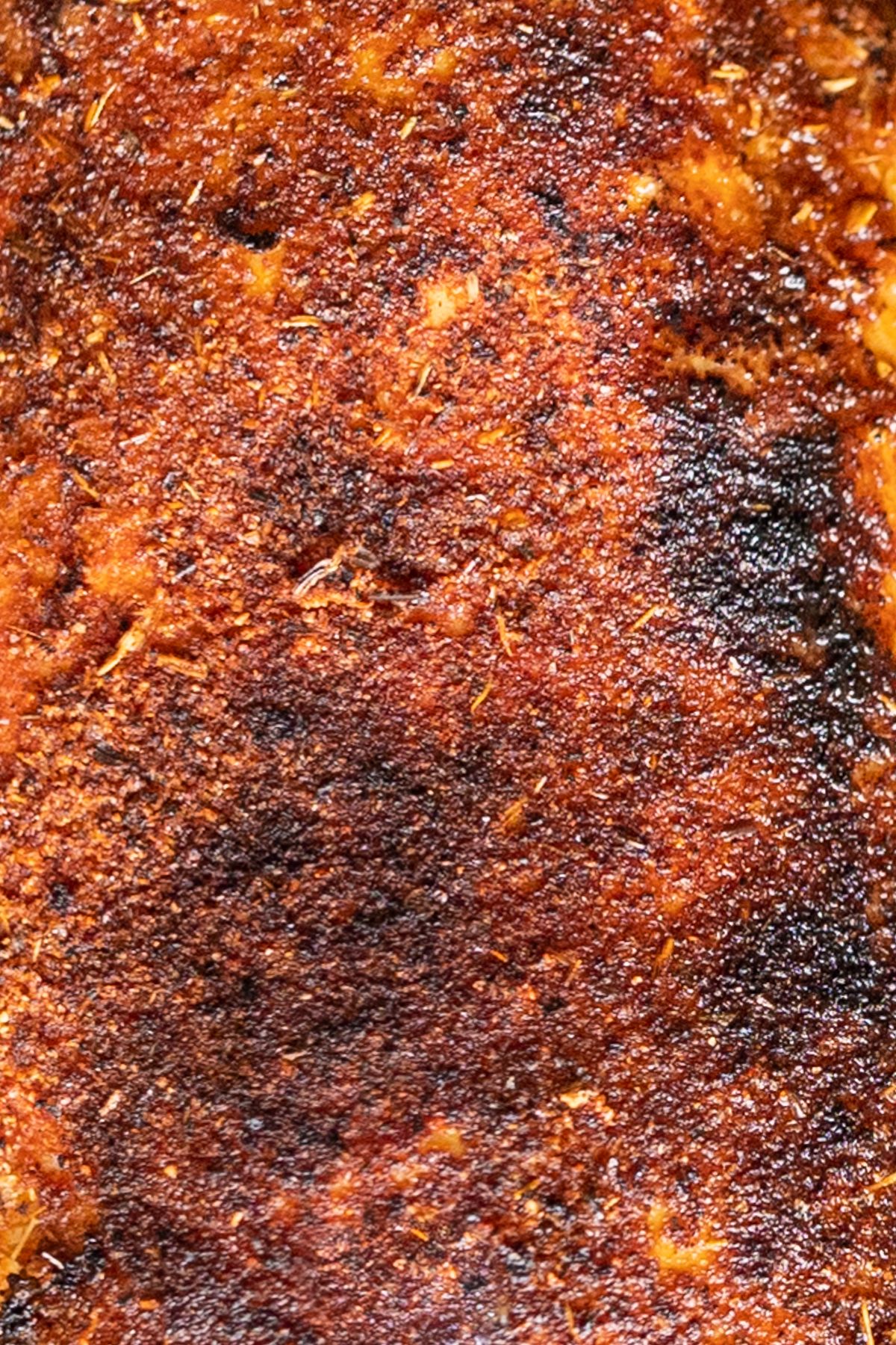 A close up of the seasoning on a blackened chicken tender.