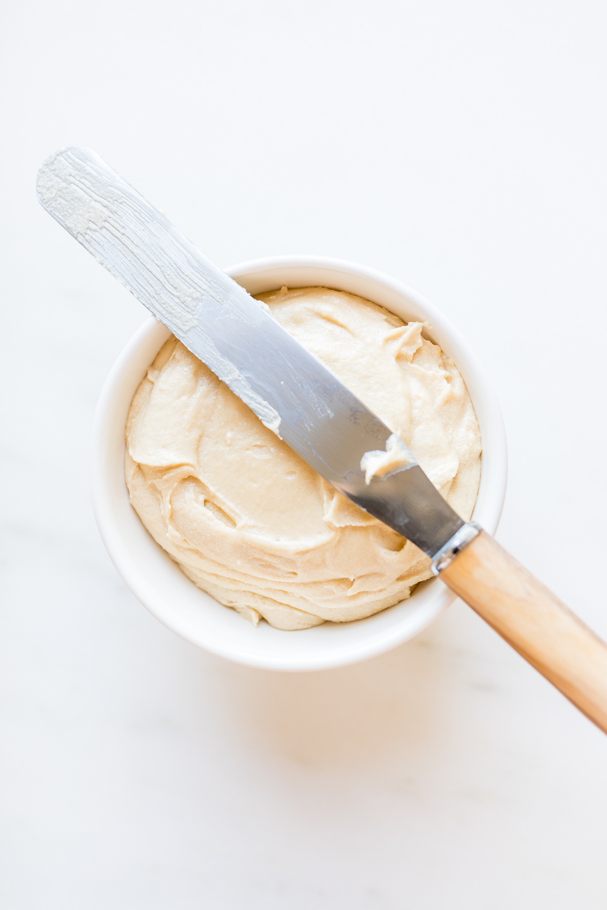 Caramel frosting in a white bowl