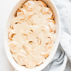 A white dish with caramel rolls.