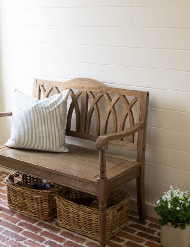 An entrance bench with storage baskets underneath.