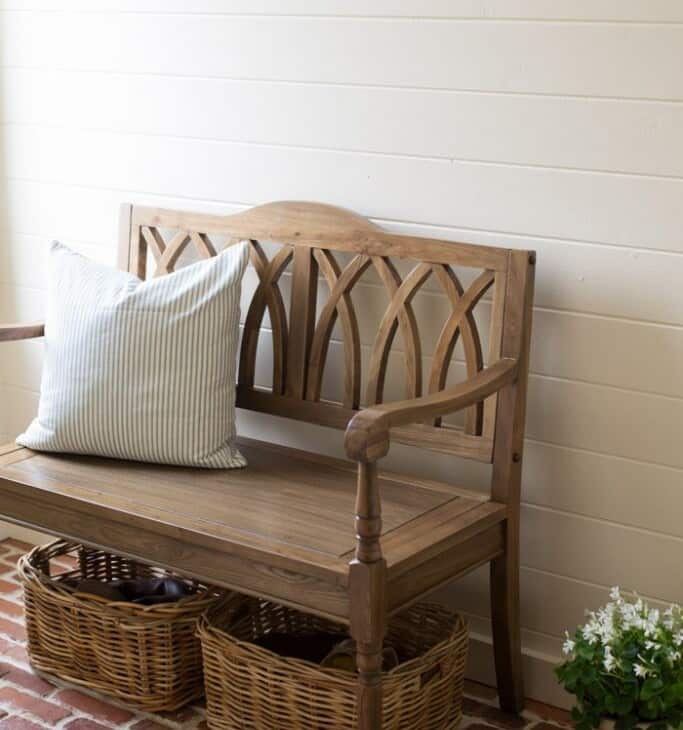 An entrance bench with storage baskets underneath.