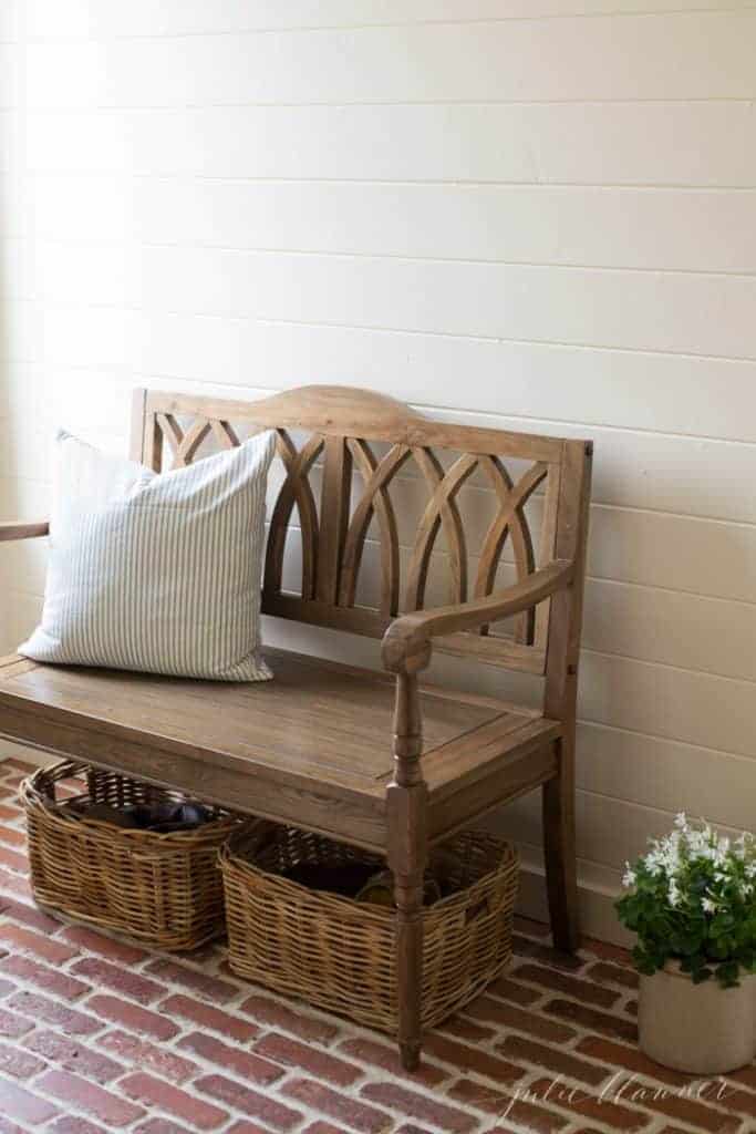 An entrance bench with storage baskets underneath.