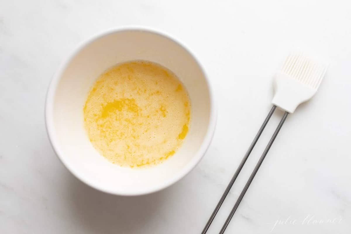 garlic butter in bowl with pastry brush