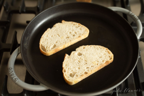 Bread on a stovetop pan for a gourmet grilled cheese.