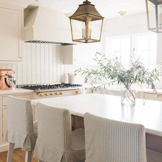 a cream kitchen with slipcovered ikea stools.