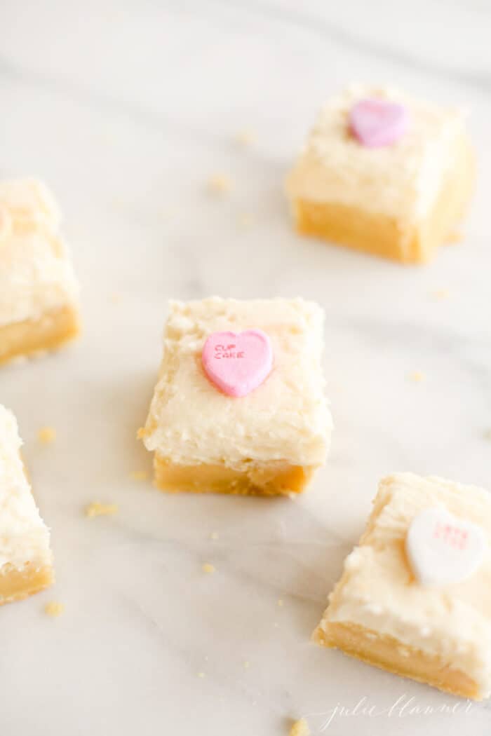 frosted sugar cookie bars on marble surface