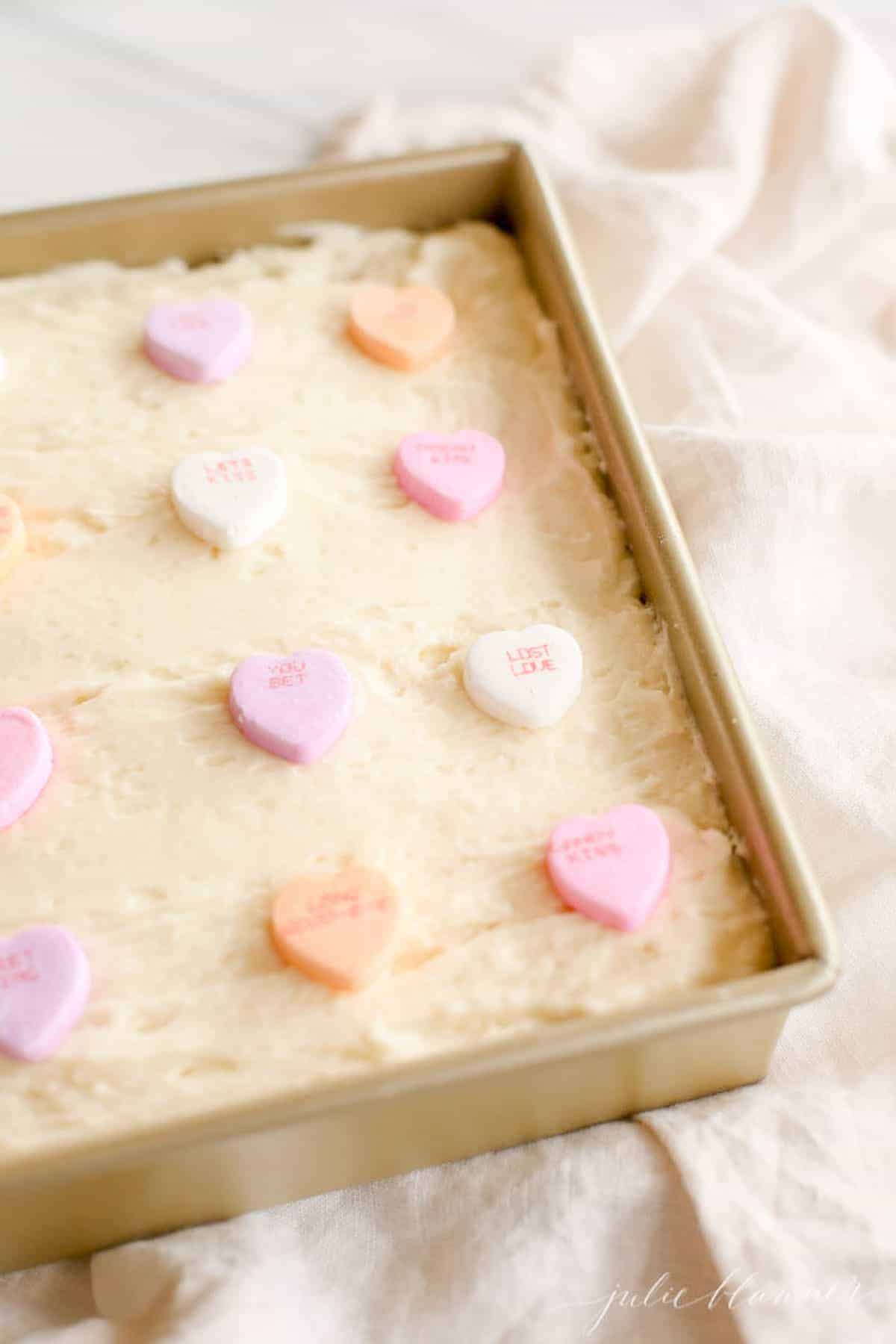 frosted cake in gold baking dish