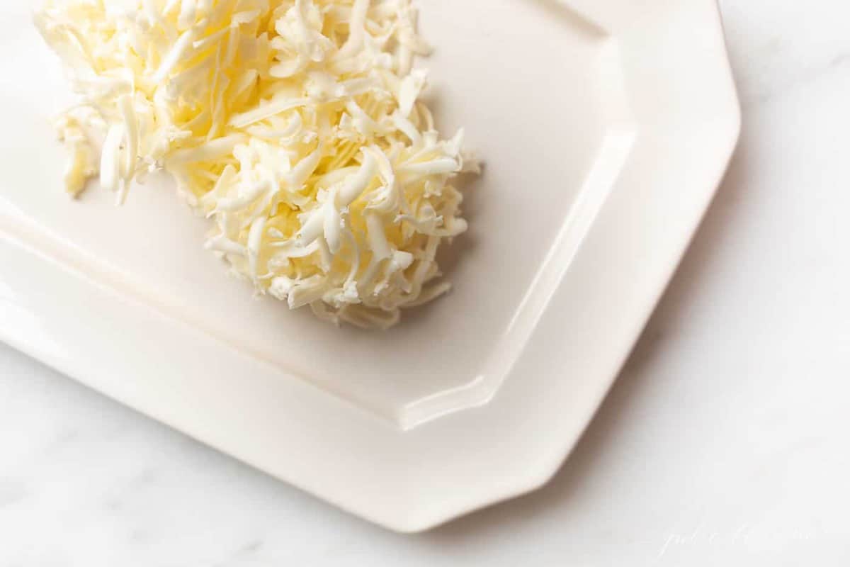 A pile of shredded butter on a white platter..