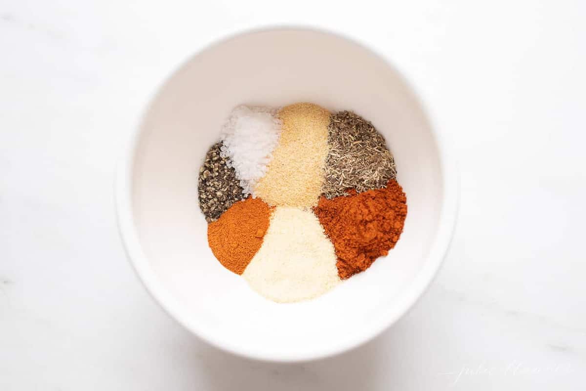 A white bowl with a blend of seven spices to make blackened seasoning.
