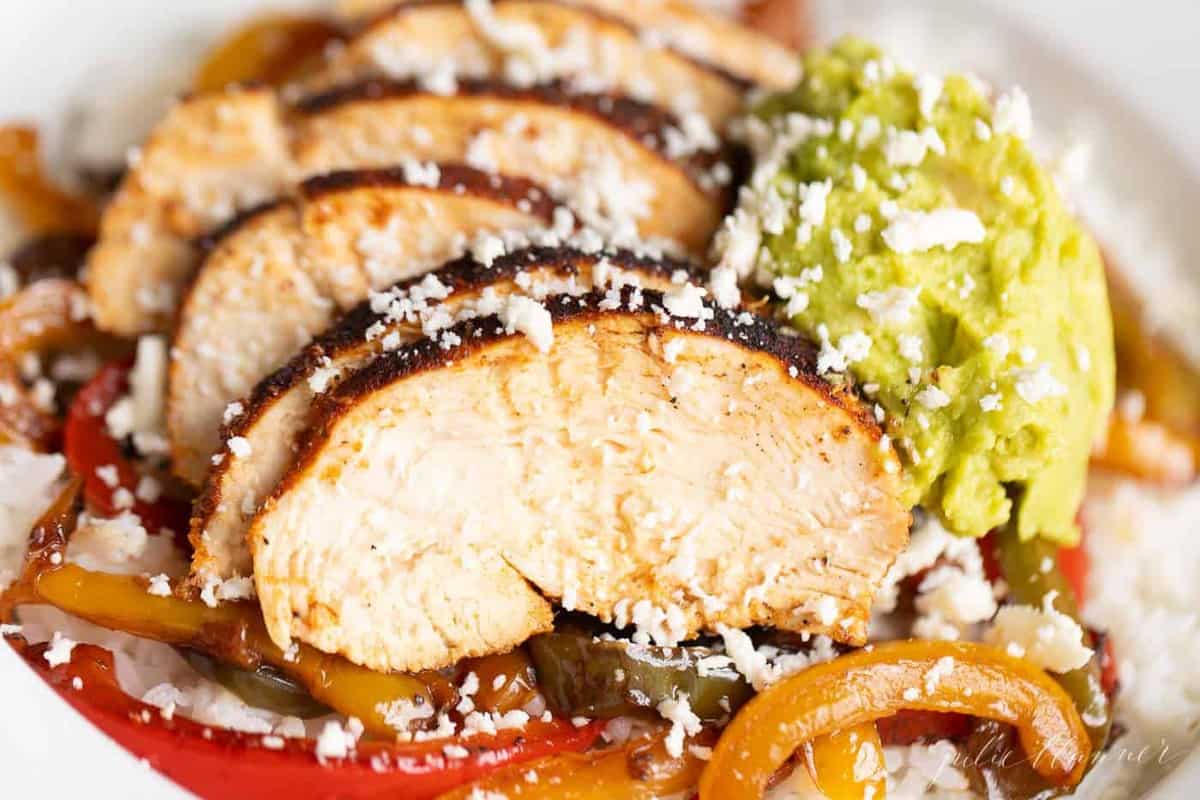 closeup of chicken over rice with fajita peppers