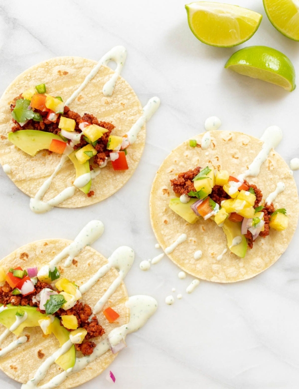Chorizo tacos topped with avocado, pineapple and lime crema.