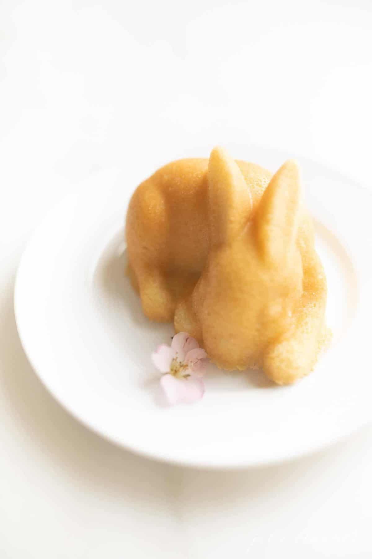An easy easter dessert of a single bunny cakelet on a white plate.