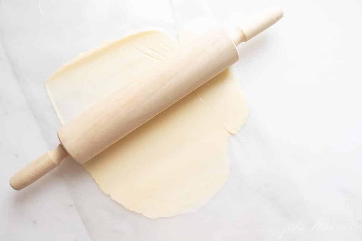 Learn how to soften butter with a rolling pin on a marble surface.
