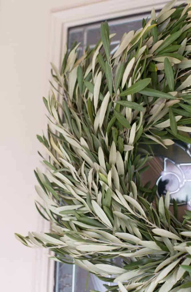 Close up of a fresh olive wreath used for minimalist seasonal decorating.