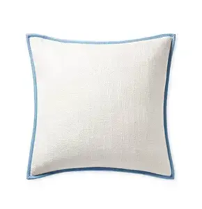 Square white pillow with a textured fabric surface, featuring a simple blue border around the edges, shown on a plain background.