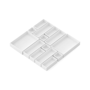 A white modular organizer tray with multiple rectangular and square compartments arranged in a geometric pattern, perfect as drawer organizers for keeping items neatly separated.