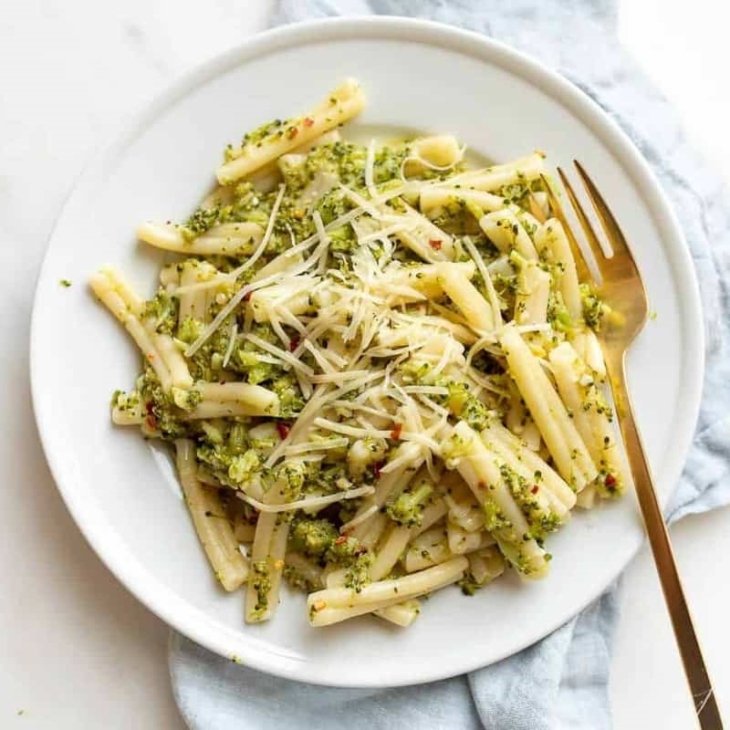 A white plate full of broccoli pasta