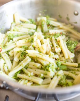 A broccoli pasta recipe inside a stainless steel pot on a stovetop