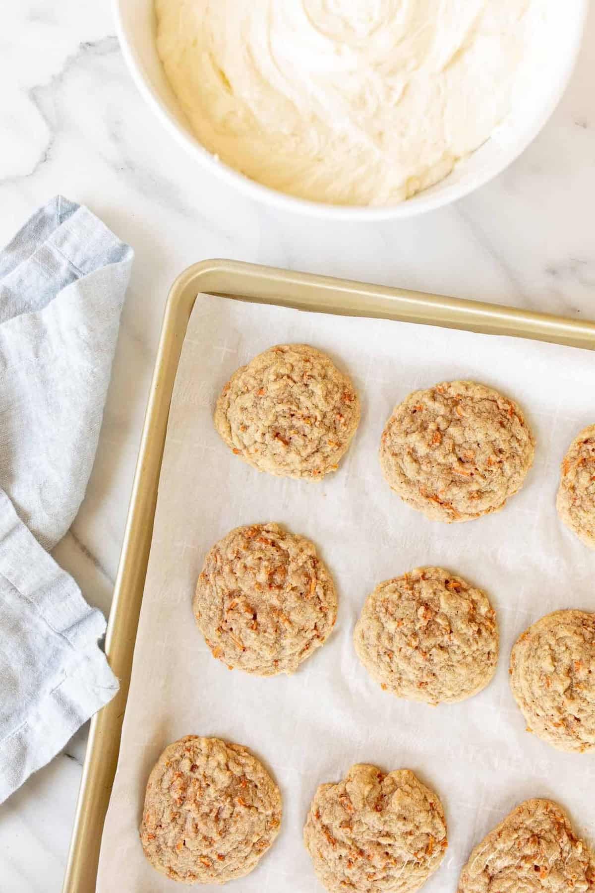Gold baking sheet with carrot cookies.