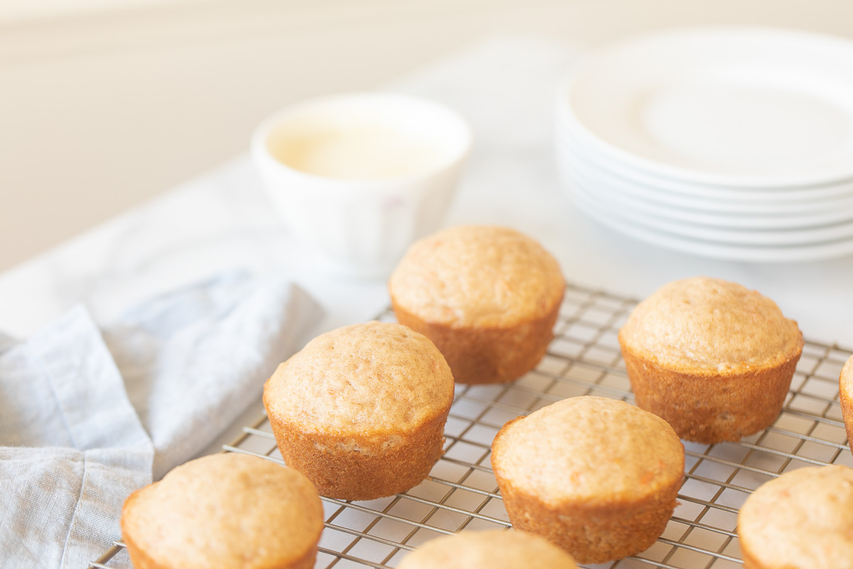 Carrot cake muffins are sitting on a cooling rack.