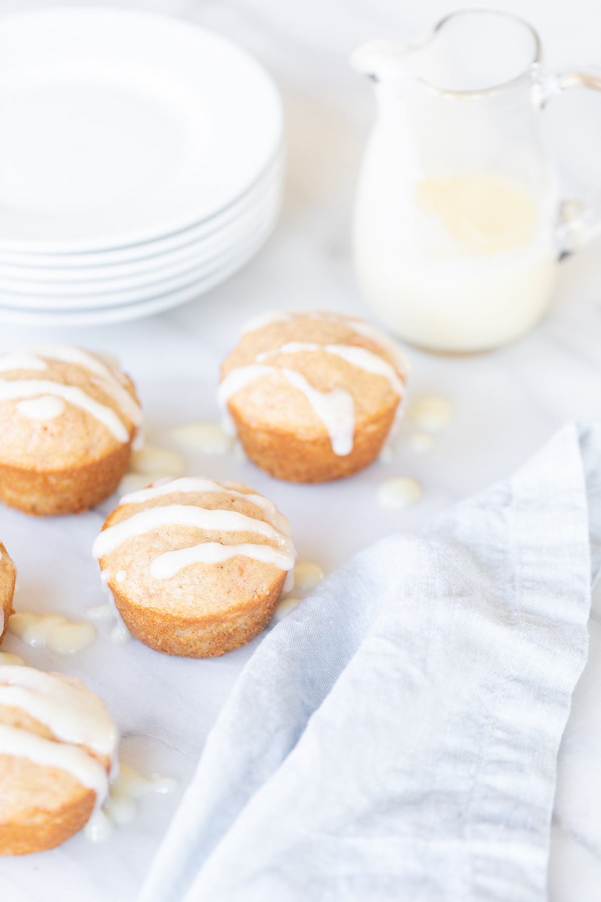 Carrot Cake Muffins with icing on a white plate.
