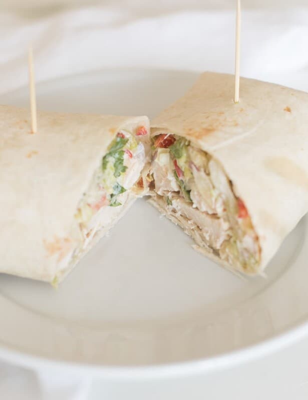 White plate with a chicken wrap, cut in half
