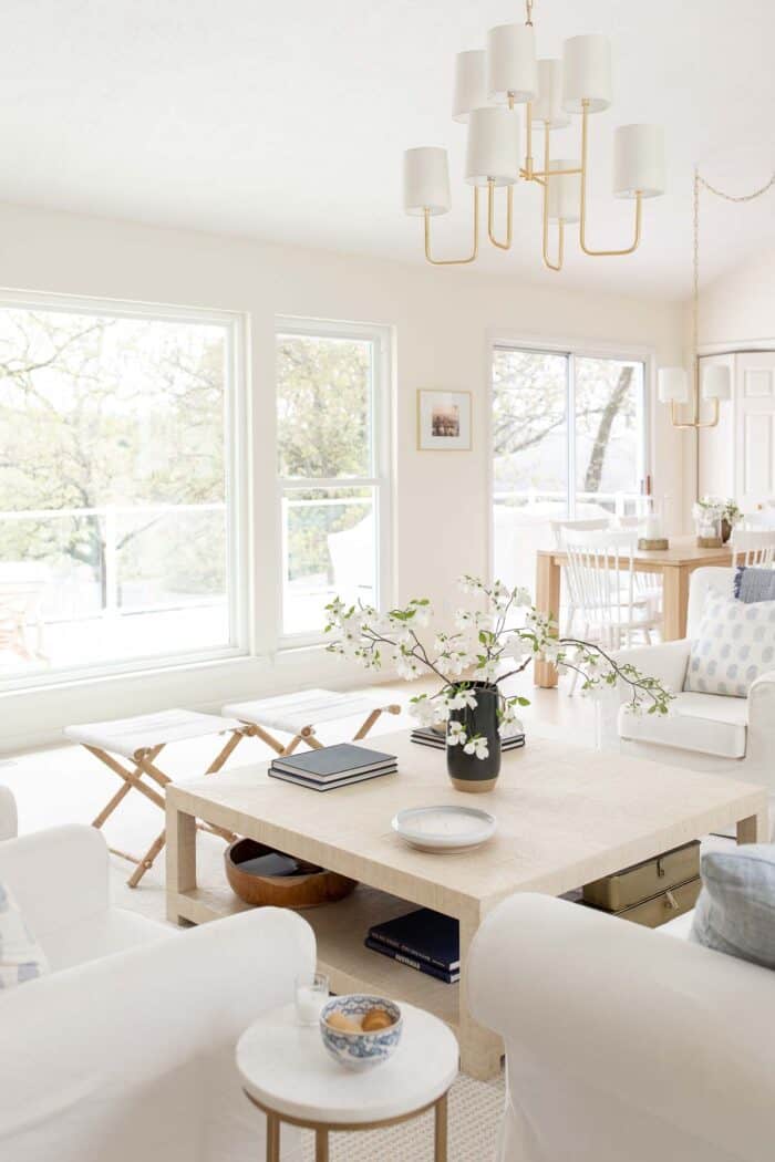 coastal modern living room with raffia coffee table and gold chandelier