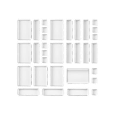 A set of white trays used as kitchen drawer inserts for silverware organization, placed on a white background.