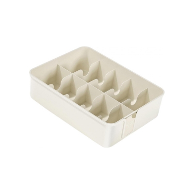 A white plastic tray with four compartments, perfect as a kitchen drawer organizer.