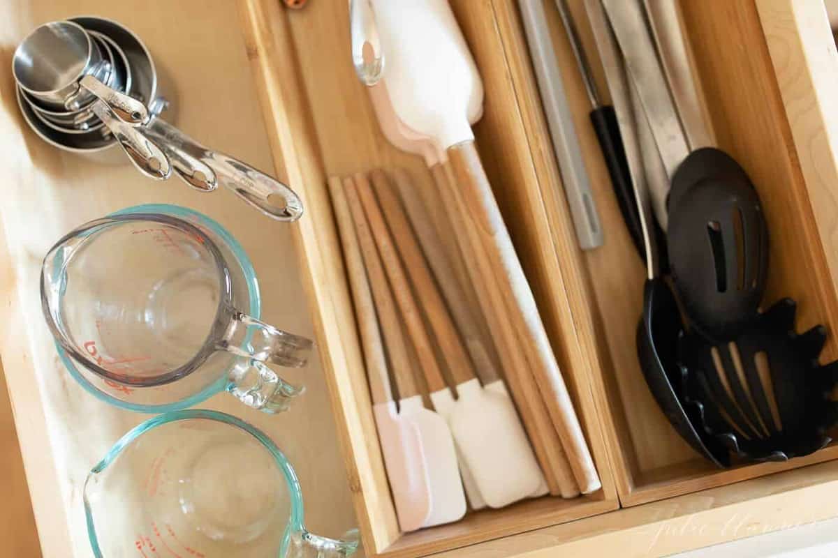 Kitchen drawer inserts in a kitchen drawer, utensils neatly organized.