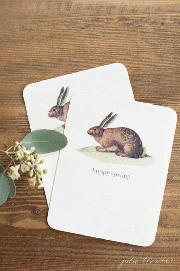 A wooden surface with sweet printable Easter decorating card ideas.