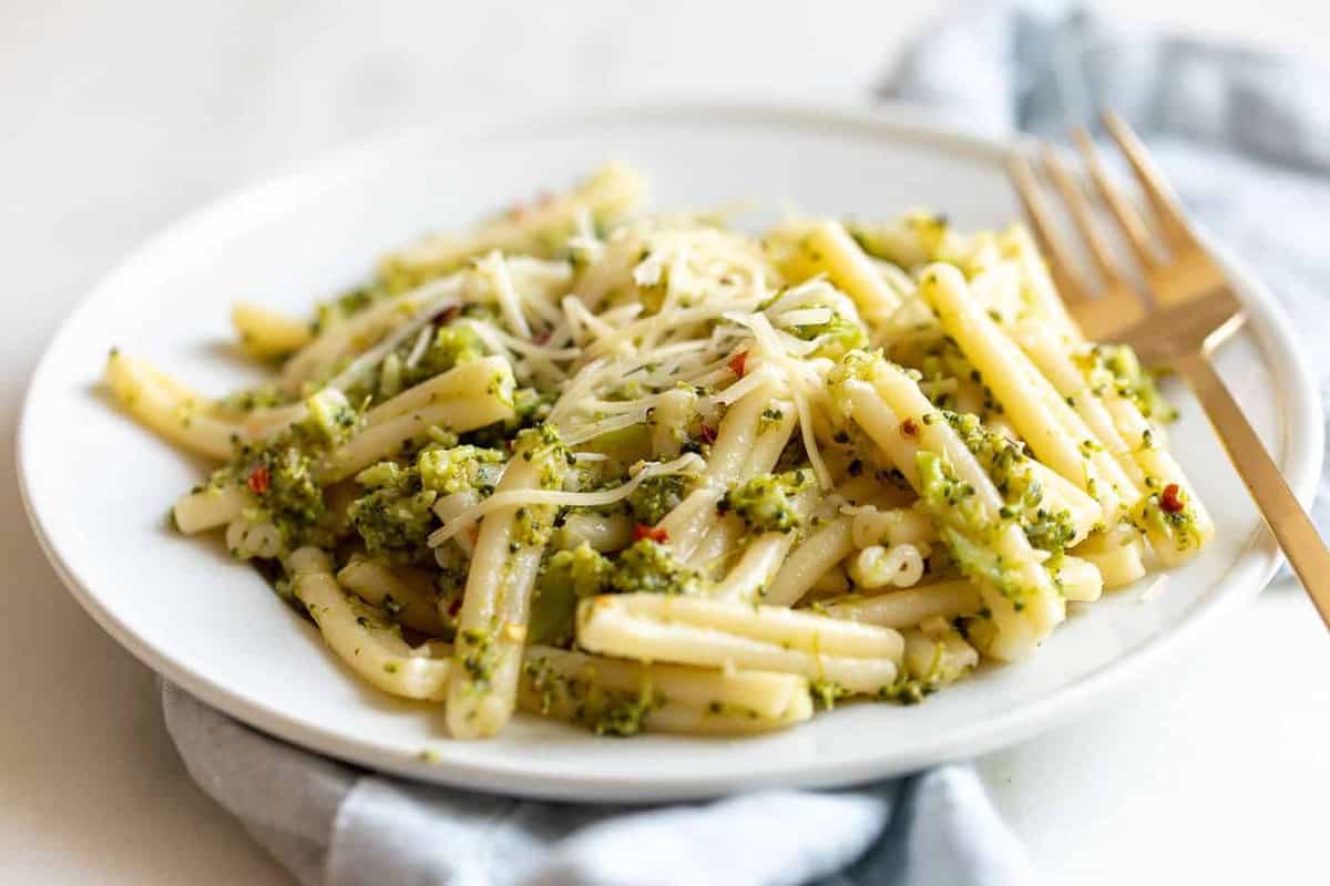 Broccoli pasta on a white plate.
