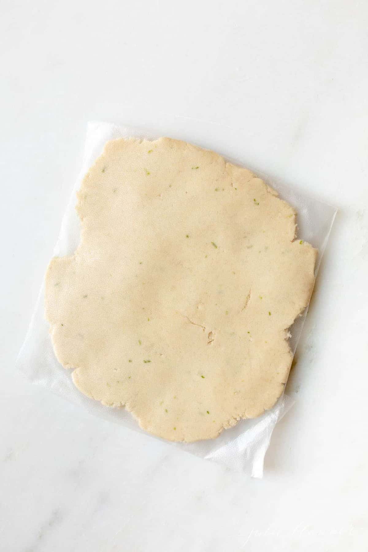 A flat disk of lime cookie dough.