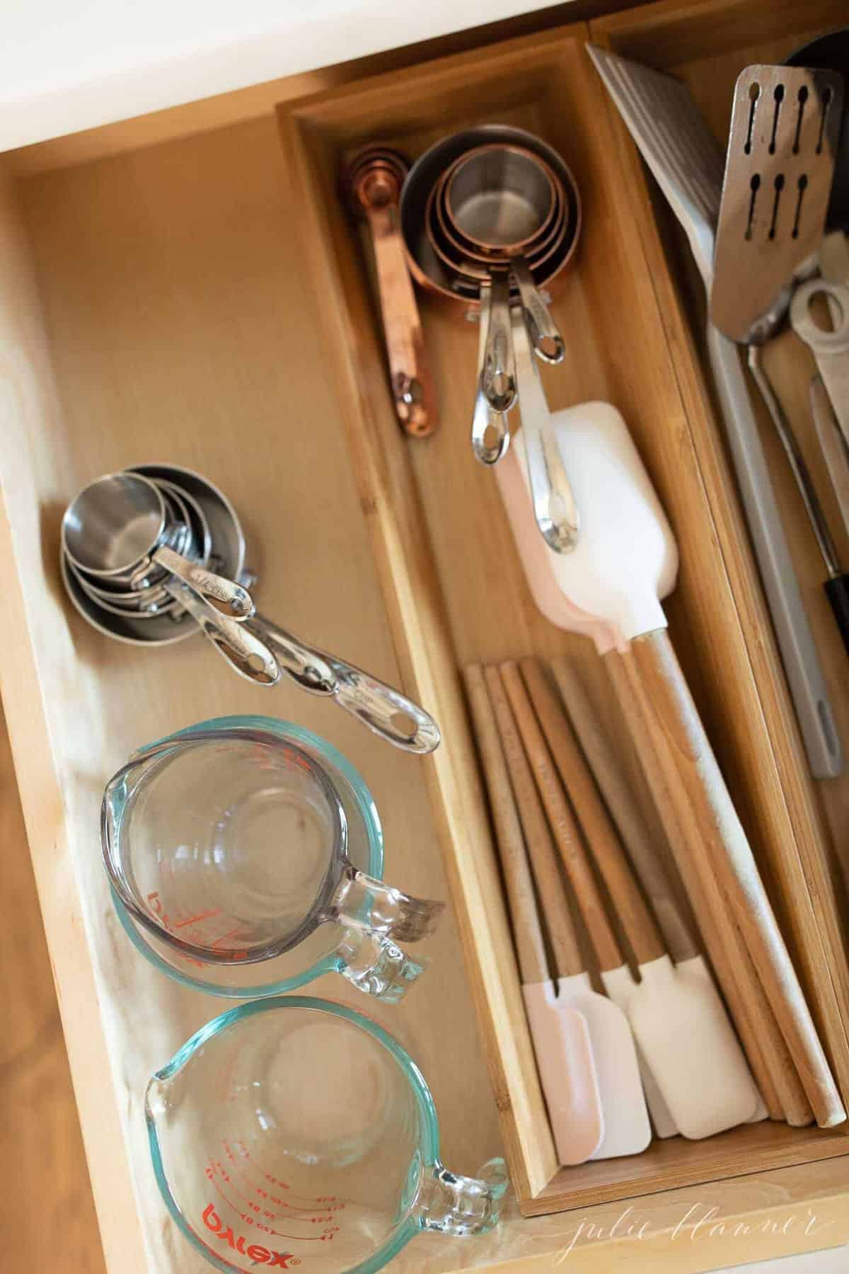 Drawer dividers in a kitchen drawer organization photo.