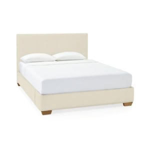 Beige upholstered platform bed with a rectangular headboard, white bedding, and two pillows, set against a plain white background.