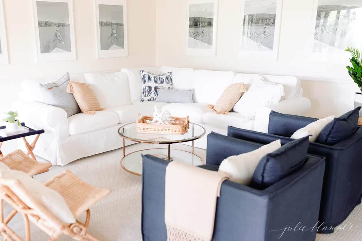 A modern living room with a round glass coffee table. 