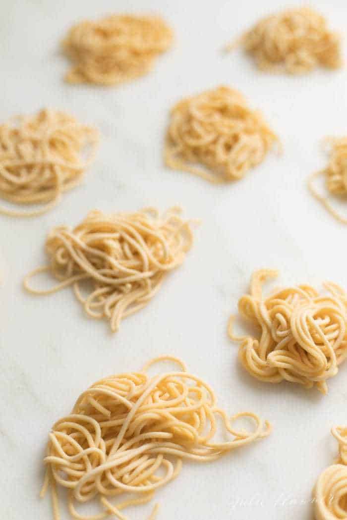 Small piles of homemade pasta made from pantry essentials.