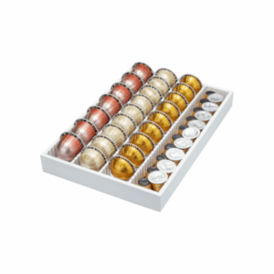 A white tray with drawer dividers holds four rows of assorted coffee pods, each row containing six pods in metallic bronze, beige, gold, and silver shades.